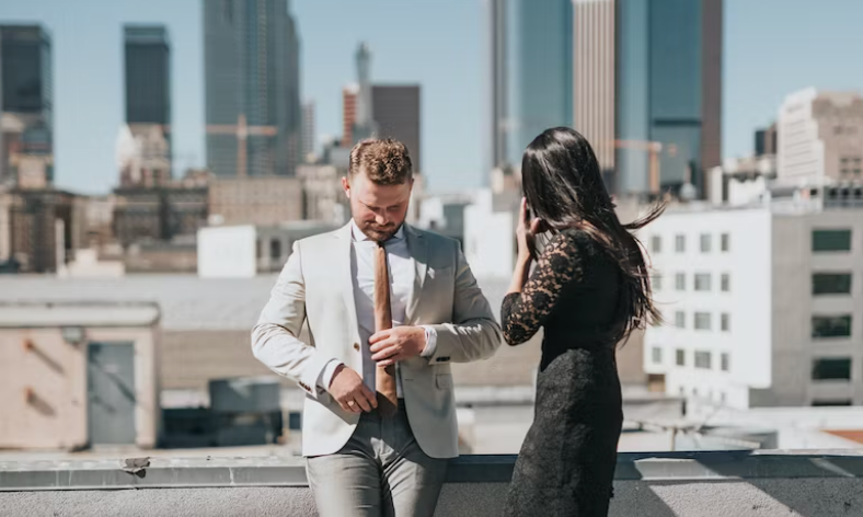 Date Night Outfit Ideas for Every Occasion. Couple Dressed nicely in front of city scape.